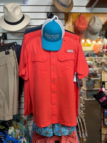 Cathy's Boutique display of merchandise including Men's shirts and tropical wear
