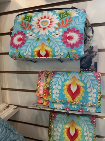 Cathy's Boutique display of merchandise including purses and tropical wear