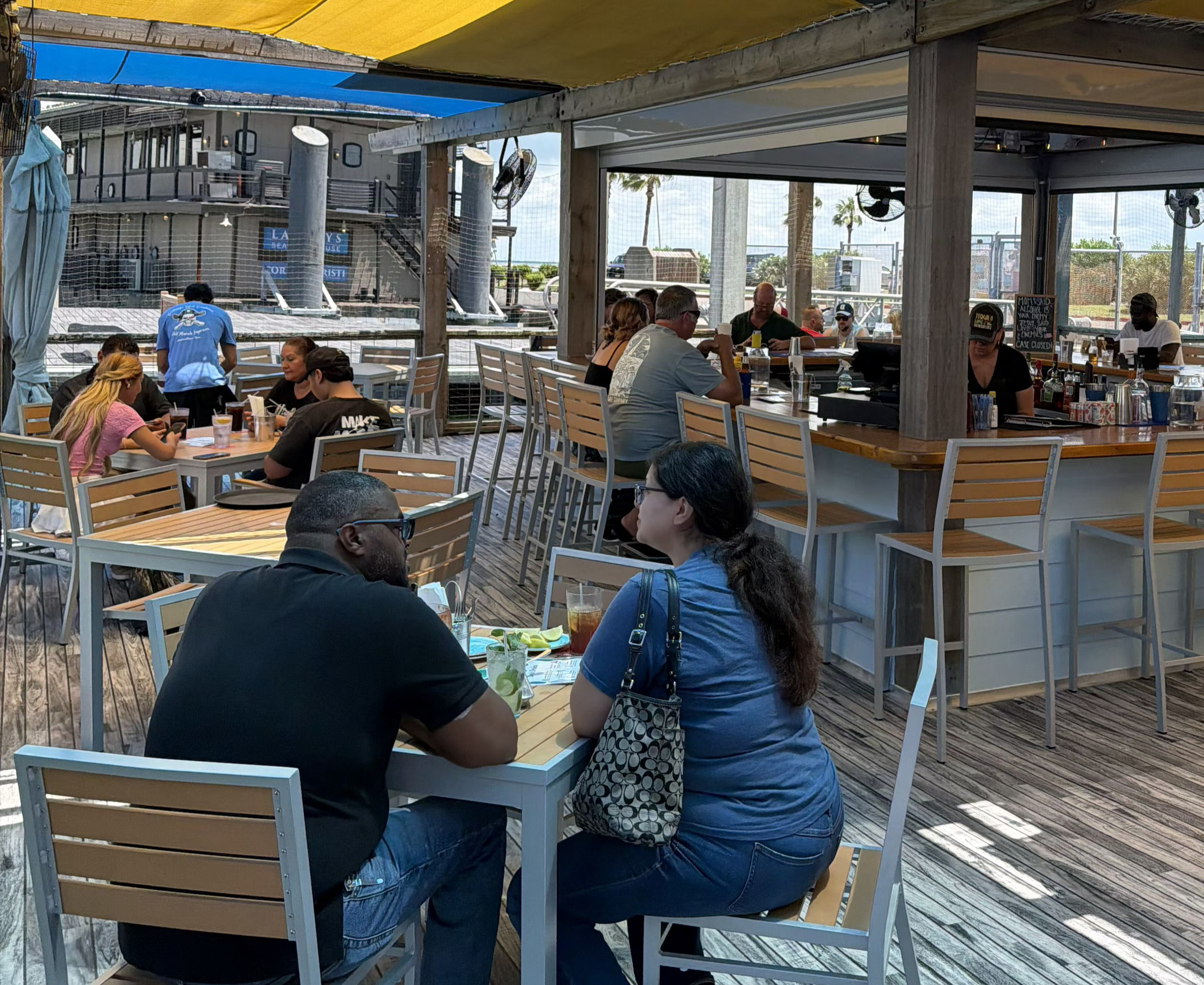 Harrison's Landing Back Patio with Bar in background and customers eating